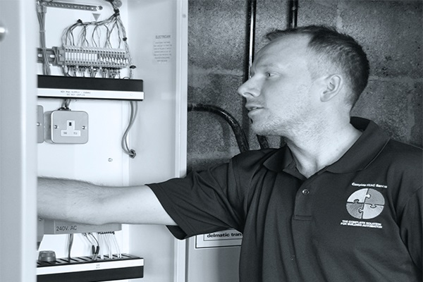 engineer servicing hvac plant controls in control panel in London
